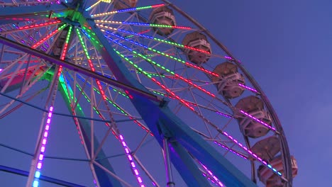 A-ferris-wheel-spins-and-is-brightly-lit