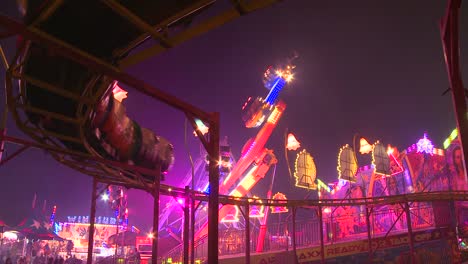 A-small-roller-coaster-at-an-amusement-park-carnival-or-state-fair-at-night--1