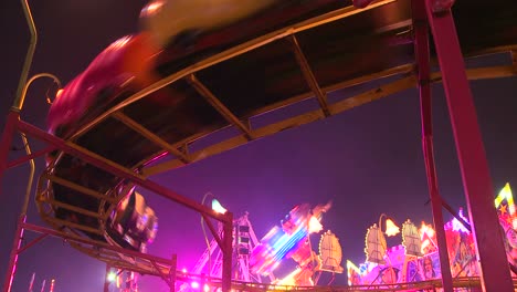 A-small-roller-coaster-at-an-amusement-park-carnival-or-state-fair-at-night--2