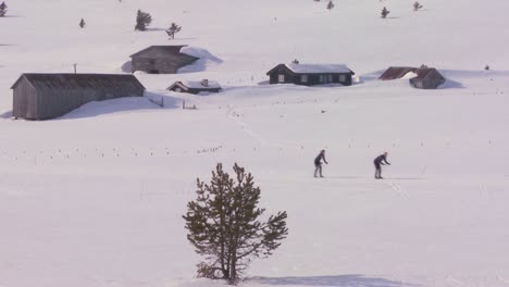 Cross-country-skiers-move-across-a-snowy-landscape-in-Norway