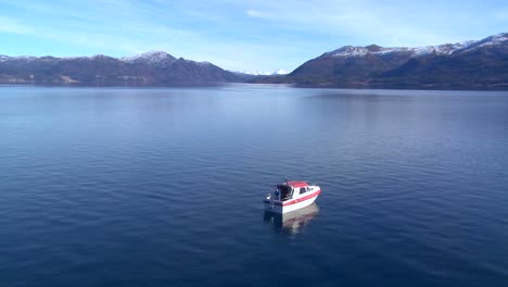 Wide-shot-of-a-man-on-a-motorboat-fishing-in-Norway