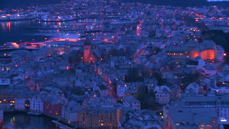 Zoom-out-from-a-high-angle-view-at-dusk-over-town-of-Alesund-Norway