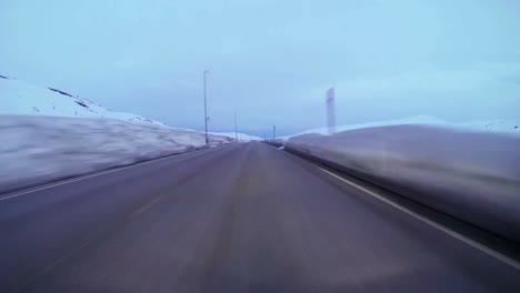 POV-shot-of-a-car-traveling-at-high-speed-along-a-montaña-road-with-ice-and-snow-3