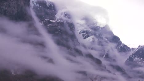 Clouds-and-fog-hang-reveal-amazing-mountains-along-a-fjord-in-Norway-1