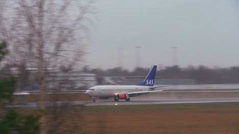 A-plane-comes-in-for-a-landing-at-an-airport-on-a-rainy-day