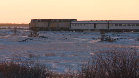 A-VIA-rail-Canada-passenger-train-passes-across-frozen-tundra-1