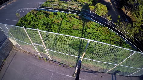 A-birds-eye-vista-aérea-over-a-basketball-player-shooting-a-layup-on-an-outdoor-court-2