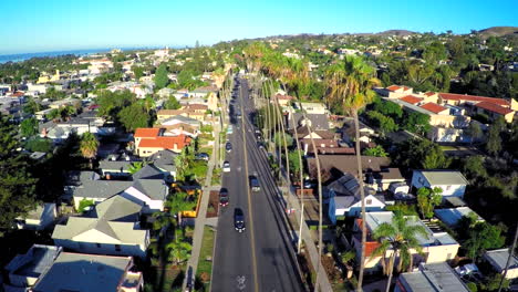 Aerial-shot-over-a-palm-tree-lined-street-in-Southern-California