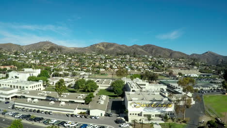 An-aerial-shot-rising-to-reveal-the-city-of-Ventura-California-and-the-high-school-and-mountains