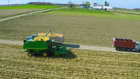 Excellent-aerial-over-a-rural-American-farm-with-corn-combine-harvester-at-work