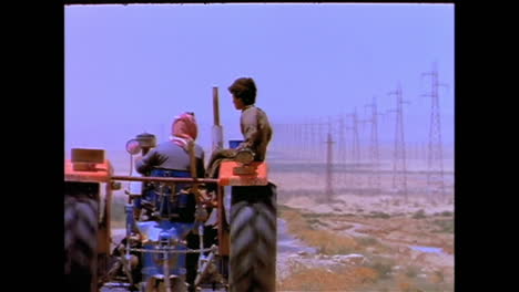 A-tractor-with-two-boys-on-it-drives-the-lonely-road-between-Syria-and-Baghdad-Iraq-in-1996