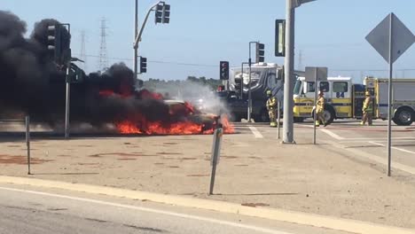 A-car-Kia-Soul-fire-burns-in-an-intersection-with-a-fire-truck-nearby-near-Ventura-California-2