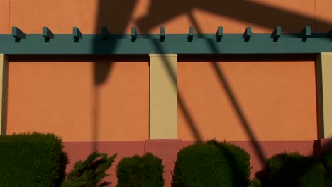 A-giant-oil-rig-casts-a-shadow-against-the-side-of-a-painted-building
