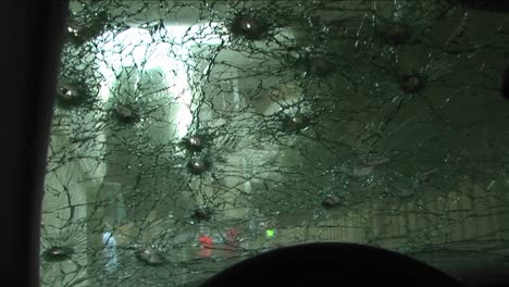 A-windshield-is-shattered-by-bullets-after-an-assassination-attempt