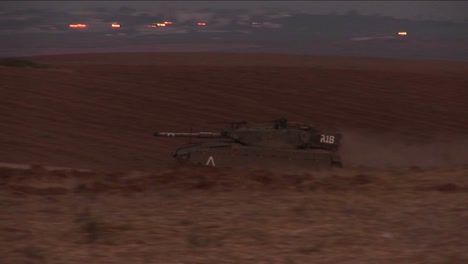 An-Israeli-tank-moves-through-a-no-man\'s-land-on-the-border-of-Israel-and-the-Gaza-Strip-1