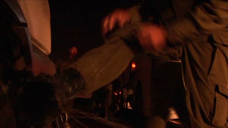 An-Israeli-soldier-adjusts-his-boots-during-a-night-patrol-operation-in-a-border-region