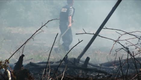 Israeli-police-and-fire-officials-work-to-put-out-a-fire-started-by-a-rocket-launched-during-the-Israel--Lebanon-war