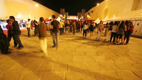 A-time-lapse-of-people-walking-around-tents-at-night-in-Morocco