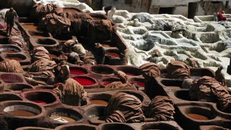 A-time-lapse-of-people-dying-clothes-in-large-clay-vats-