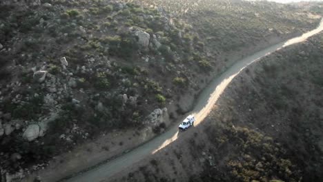 Aerial-view-of-a-border-patrol-vehicle-on-a-rocky-dirt-road