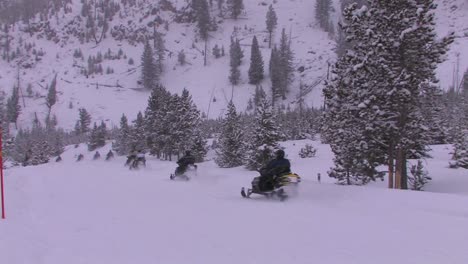 A-long-line-of-snowmobiles-heads-out-across-a-snowy-wilderness