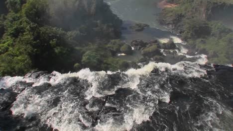 A-moving-perspective-looking-over-the-edge-of-a-waterfall-Iguacu-Falls