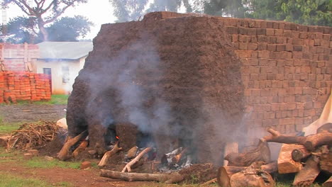 Smoke-billows-as-bricks-are-fired-at-a-construction-site-in-rural-Africa-