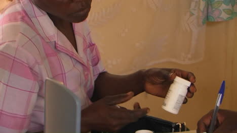 A-doctor-at-a-clinic-gives-a-woman-medication-and-instructions-for-taking