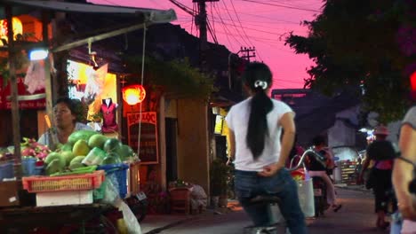 Vendors-wheel-their-wares-out-at-dusk-in-a-Vietnamese-village