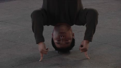 A-man-stands-on-his-head-in-traffic-in-a-city-in-China