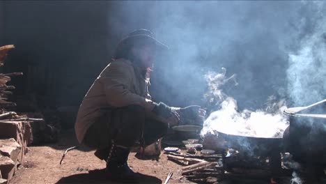 A-Chinese-cowboy-sits-by-a-fire-and-smokes