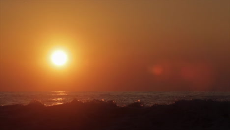 The-sun-sets-behind-beautiful-ocean-waves