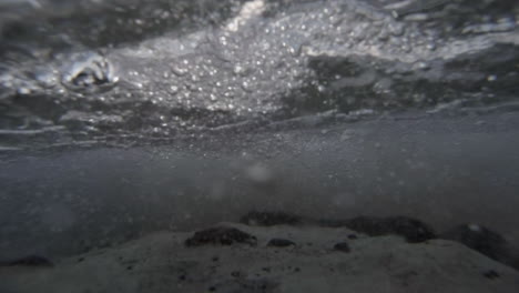 Water-level-view-of-waves-crashing-and-rolling-into-shore-in-slow-motion