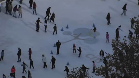 People-are-enjoying-ice-skating-on-a-snowy-floor