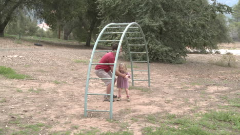 Time-lapse-of-a-father-and-daughter-playing-on-a-monkey-bars-in-Ojai-California