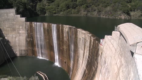 Pan-side-view-of-water-spilling-over-the-Matilija-Dam-in-Ojai-California
