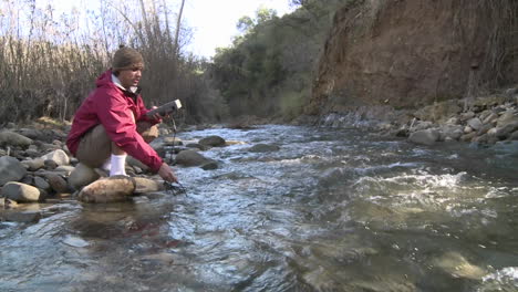Man-testing-the-water-flowing-in-San-Antonio-Creek-in-Ojai-California