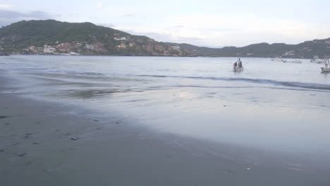 Close-up-time-lapse-of-fishing-boats-launching-from-Playa-Principal-in-Zihuatanejo-Mexico