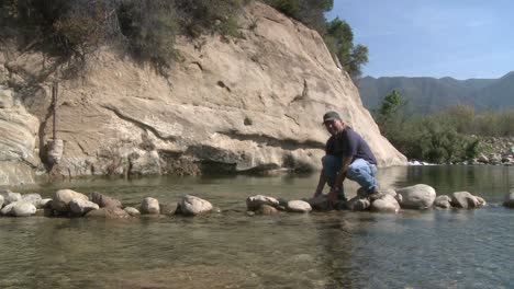 Man-removing-rocks-from-a-fish-barrier-on-the-Ventura-Río-Preserve-in-Ojai-California-1