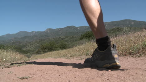 Low-angle-of-man-trail-running-on-the-Ventura-Río-Preserve-in-Ojai-California