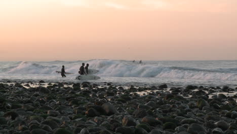 Surfers-paddling-out-at-into-the-waves-at-Surfers-Point-in-Ventura-California