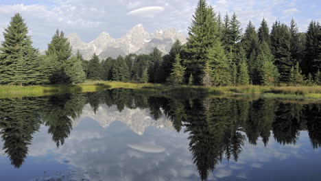 Time-lapse-motion-of-clouds-mountains-and-forest-reflecting-at-Schwabacher-Landing-in-Grand-Teton-National-Park-Wyoming