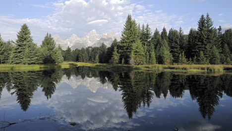 Time-lapse-of-clouds-mountains-and-forest-reflecting-at-Schwabacher-Landing-in-Grand-Teton-National-Park-Wyoming-1