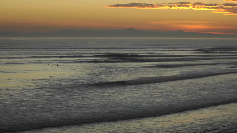 Time-lapse-close-up-of-surfers-and-waves-at-Ventura-Point-at-sunset-in-Ventura-California