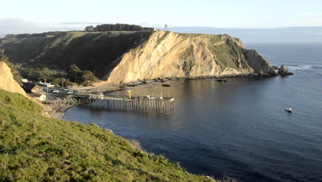 Close-up-of-Arena-Cove-and-a-calm-ocean-at-sunset-from-the-Cypress-Abbey-County-property-at-Point-Arena-California