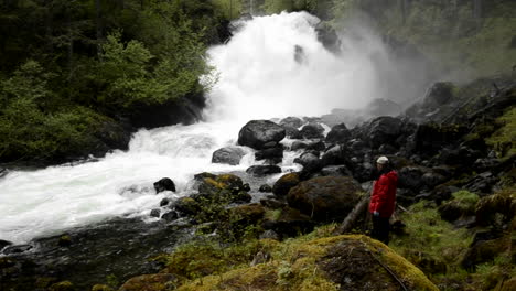 Panning-shot-of-tourist-hiking-through-the-rainforest-to-Cascade-Creek-waterfall-in-Thomas-Bay-Southeast-Alaska