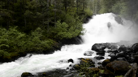 Pan-of-spring-melt-water-flowing-over-Cascade-Creek-waterfall-in-Thomas-Bay-Southeast-Alaska