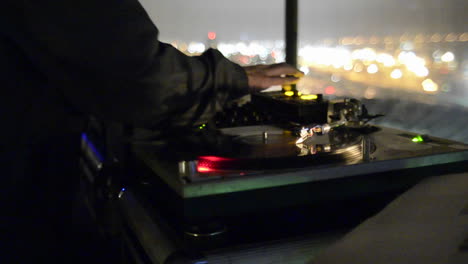 Disc-Jockey-spinning-records-on-two-turntables-and-playing-music-at-a-nightclub-in-San-Diego-California