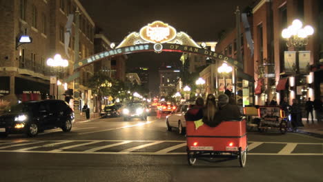 Pedicab-peddling-tourists-in-downtown-San-Diego-at-night-in-the-National-Historic-District-in-the-Gaslamp-Quarters-in-San-Diego-California