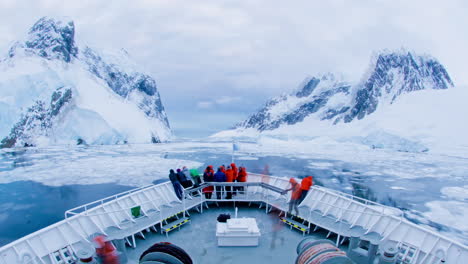 A-POV-time-lapse-shot-of-a-ship-bow-icebergs-and-tourists-passing-through-Lemaire-Channel-Antarctica